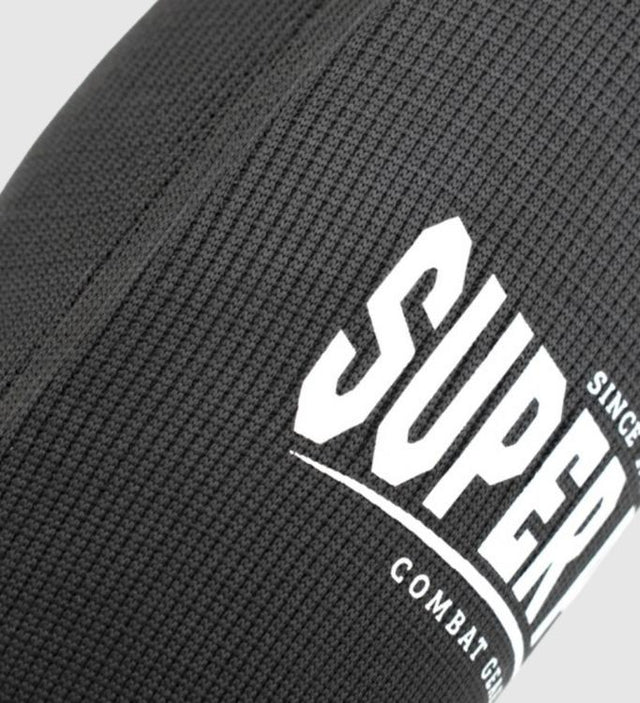 Super Pro Caneleiras Defender – Preto/Branco – Caneleiras