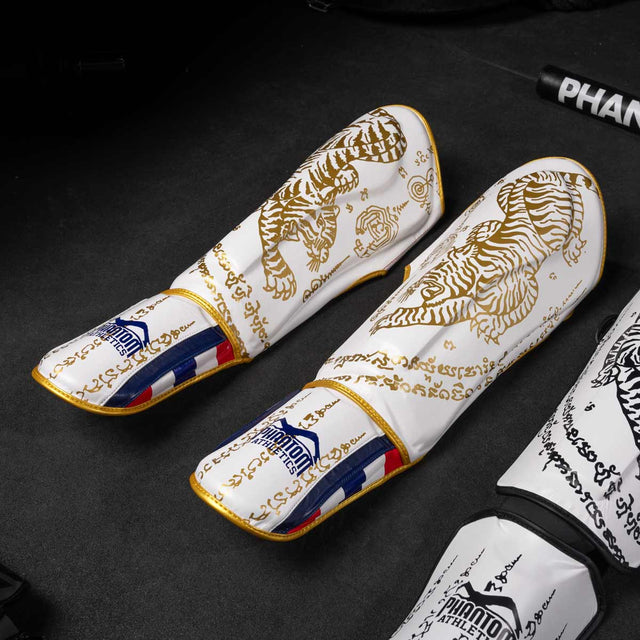 Paratibie Phantom Athletics Muay Thai – Bianco/Oro