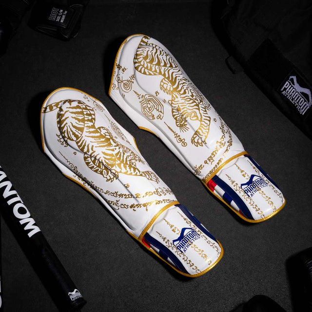 Paratibie Phantom Athletics Muay Thai – Bianco/Oro