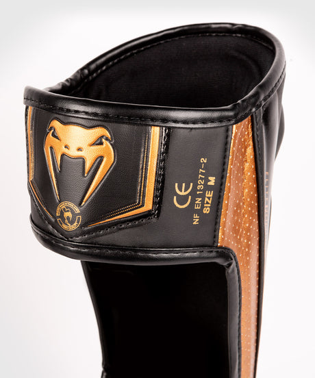 Tibiere Venum Elite Evo – Negru/Bronz