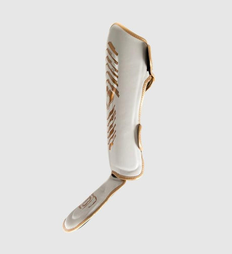 Espinilleras Booster Elite V2 – Blanco/Oro